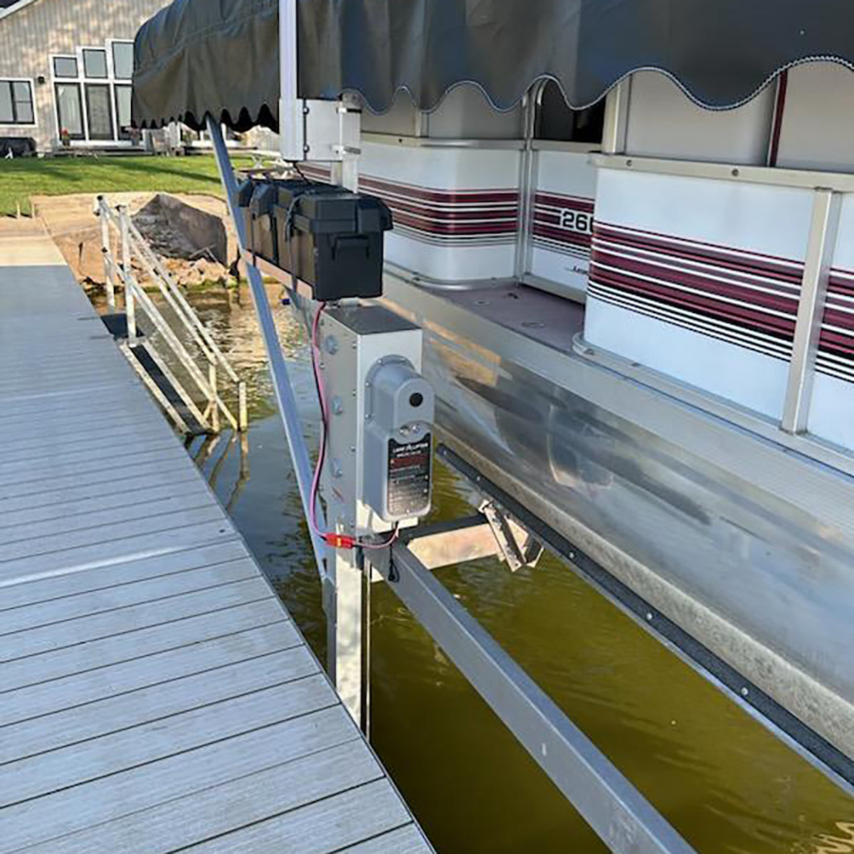 Pond skimmer attached to a pontoon boat on a dock