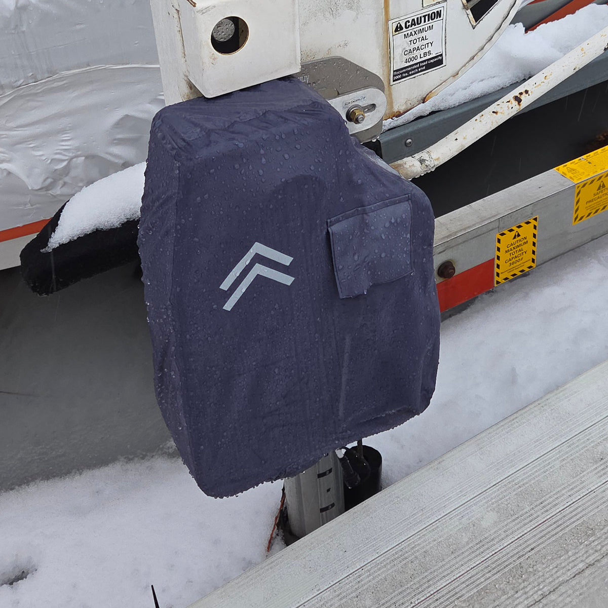 Navy blue cover with a logo on a vehicle in a snowy setting