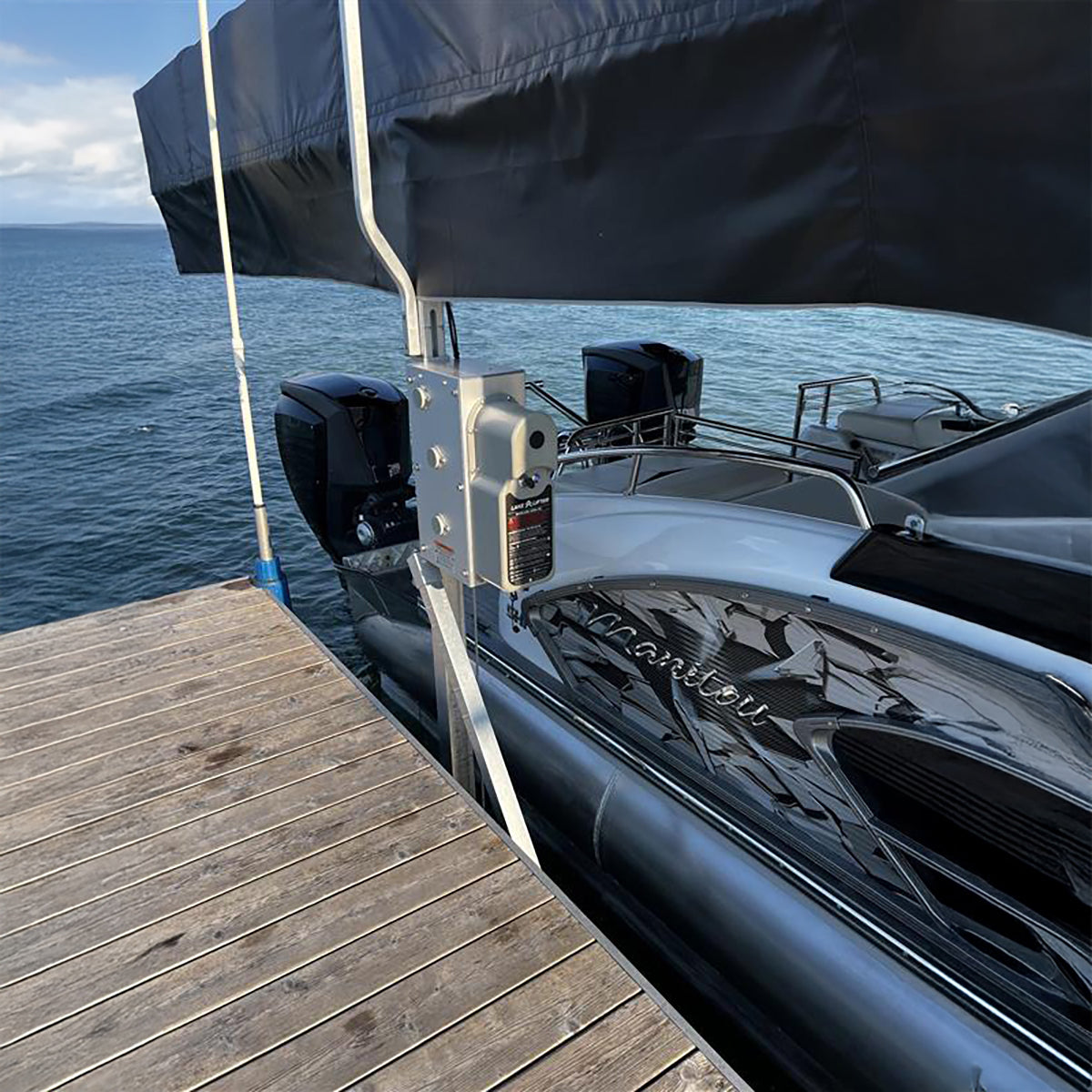 Boat docked at a wooden pier with water in the background