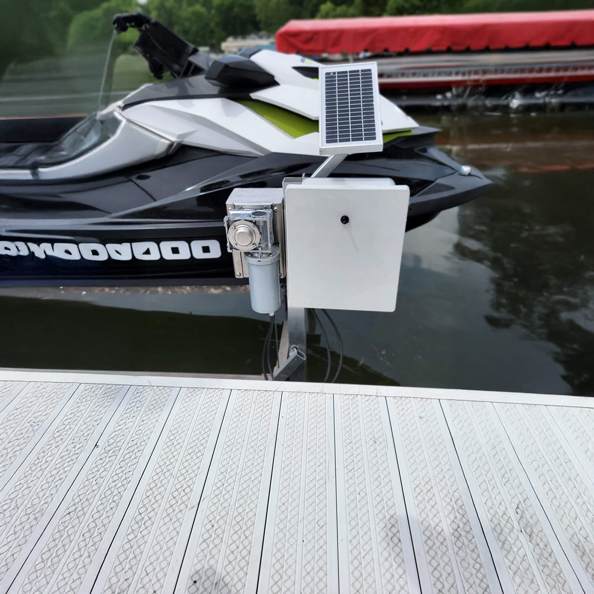 Solar panel and battery box attached to a watercraft on a dock