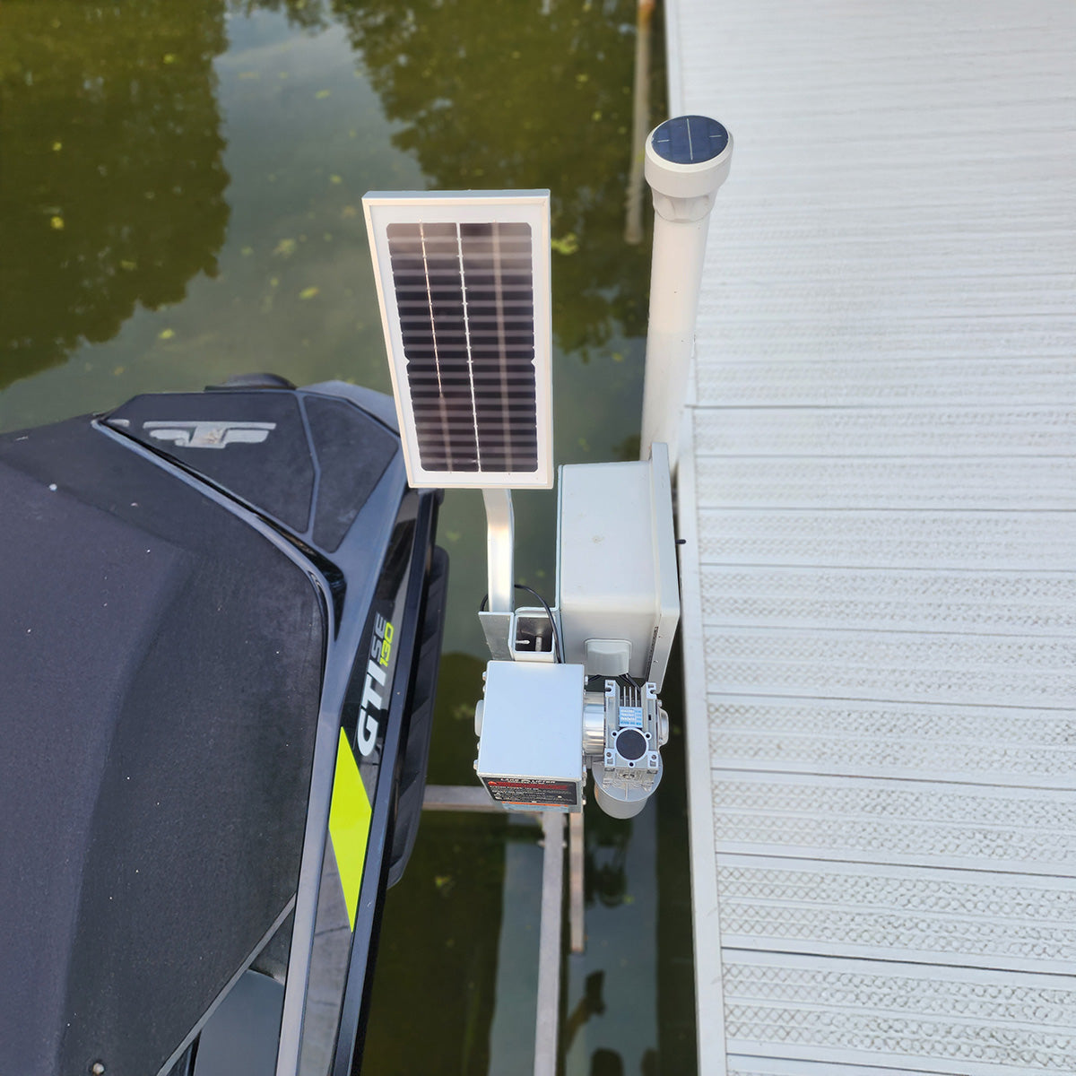 Solar panel attached to a dock with water and a building in the background
