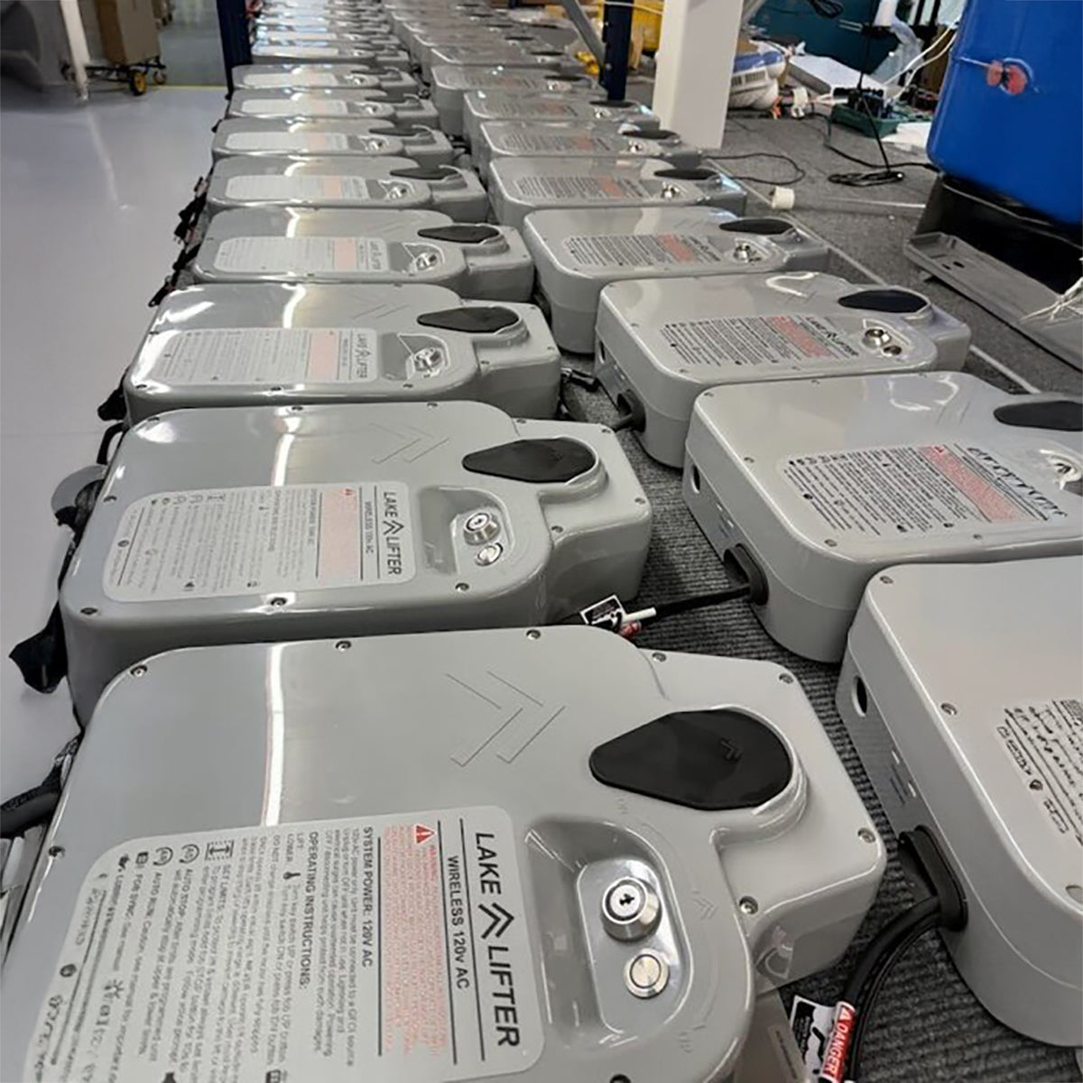 Row of Lake Lifter battery boxes on a workshop floor