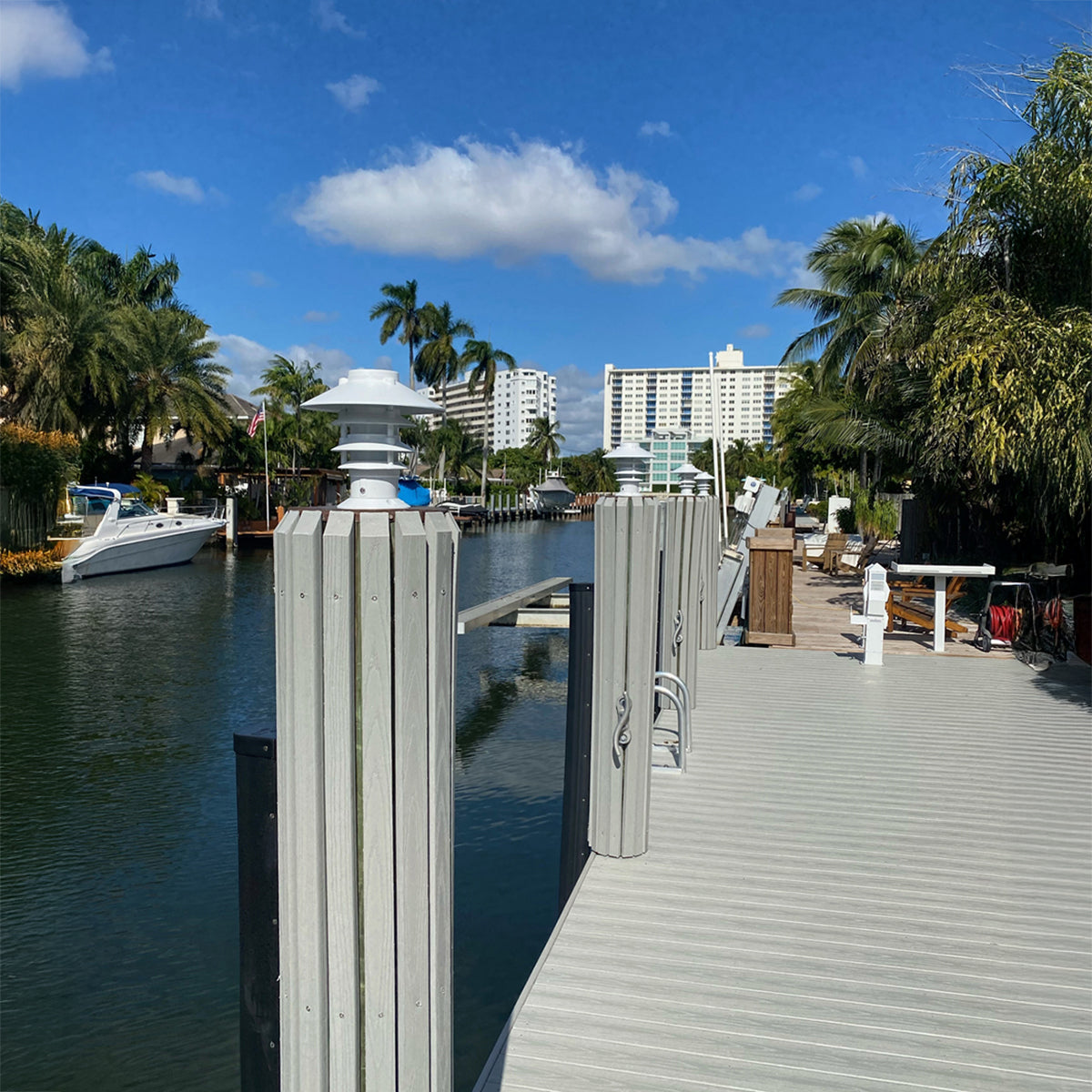 Boardwalk along a canal with boats and buildings in the background