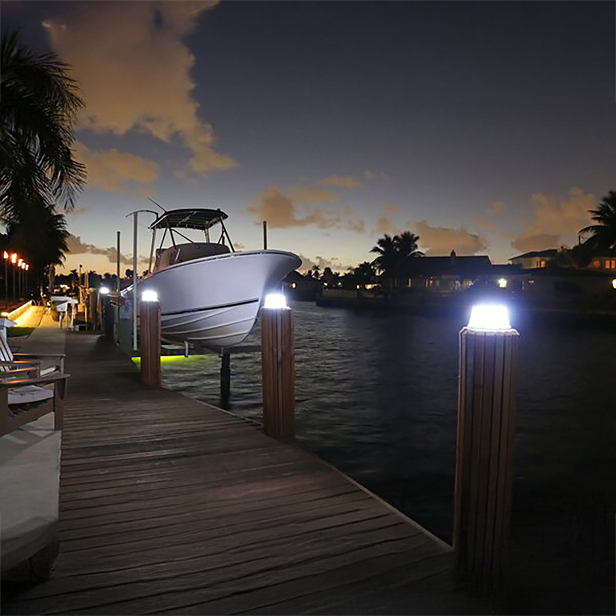 Boat on a dock at night with illuminated posts