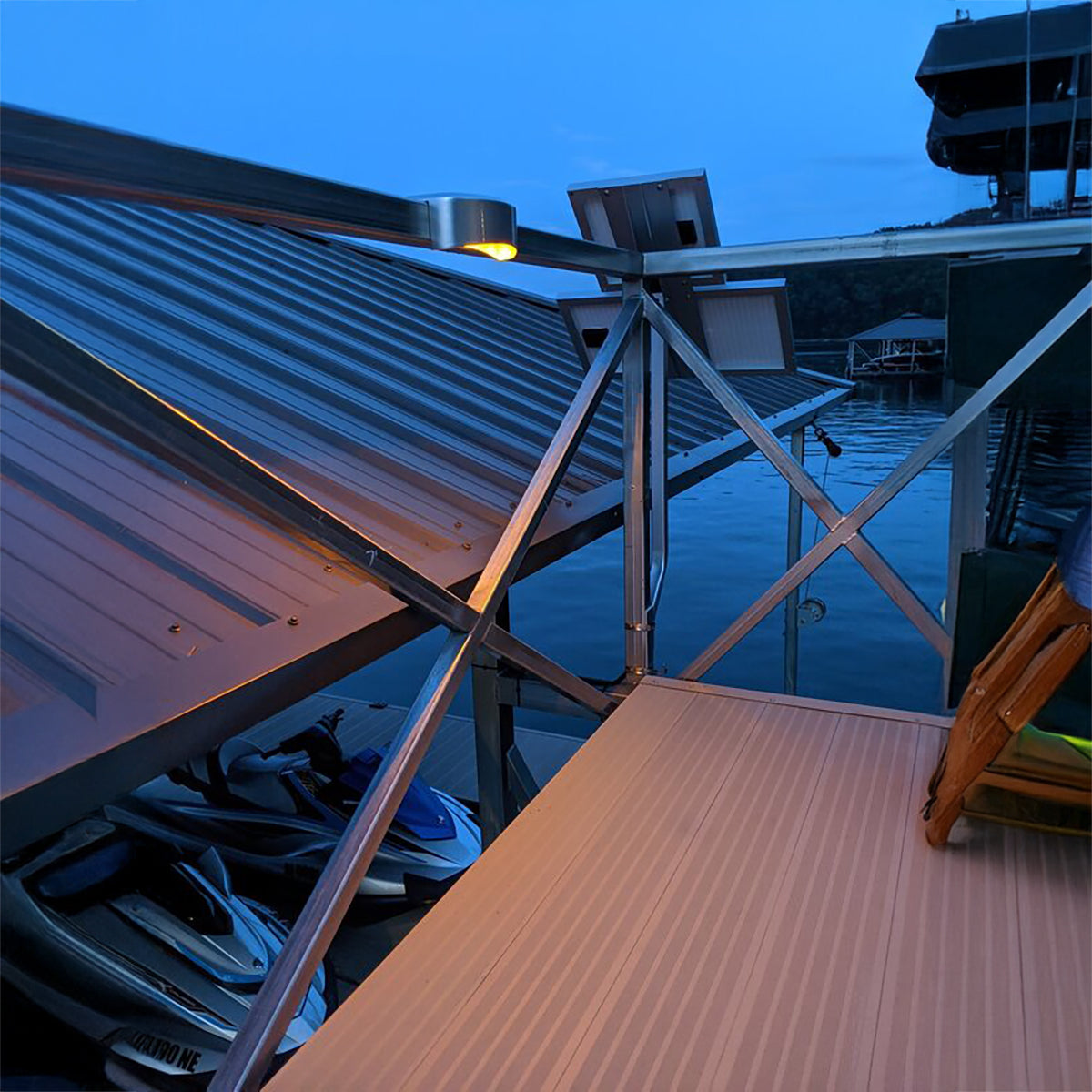 Dock with metal railing and wooden platform at night