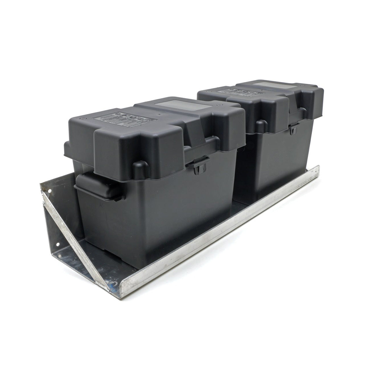 2 black plastic battery boxes sitting on a wall mounted dual battery tray.