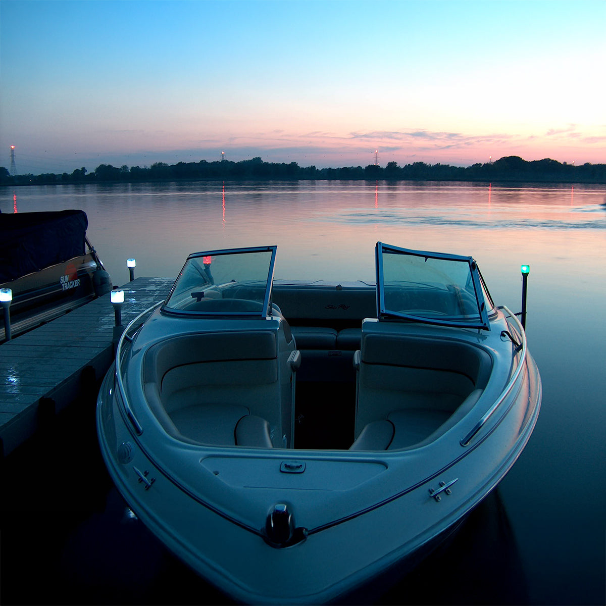 White boat on a lake at sunset