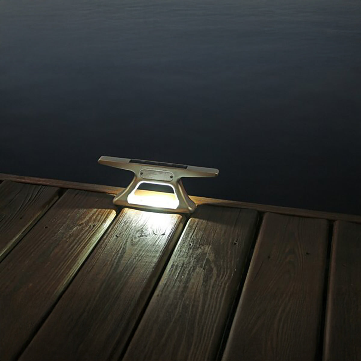 Solar light fixture on a wooden dock at night