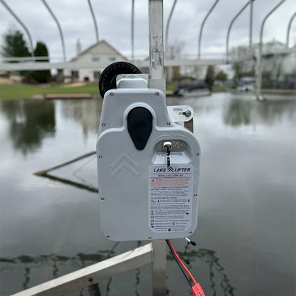 Lake lifter device on a post with a lake and house in the background