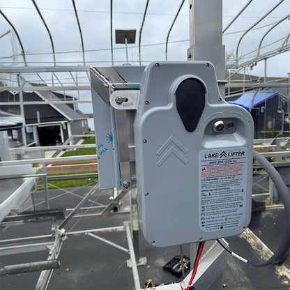 Lake Lifter wireless hoist on a metal structure with a building in the background