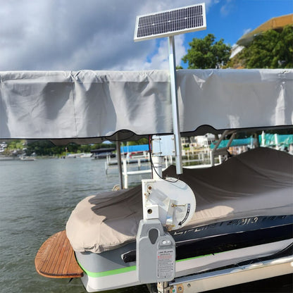 Boat with solar panel on a dock with water and sky in the background