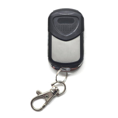 Black remote control with keychain on a white background
