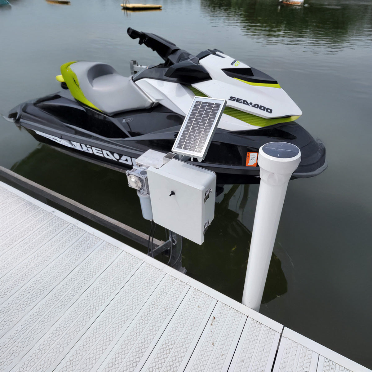 SEADOO watercraft with solar panel and battery pack attached, docked at a pier.