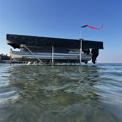 Pontoon boat on water with a clear blue sky