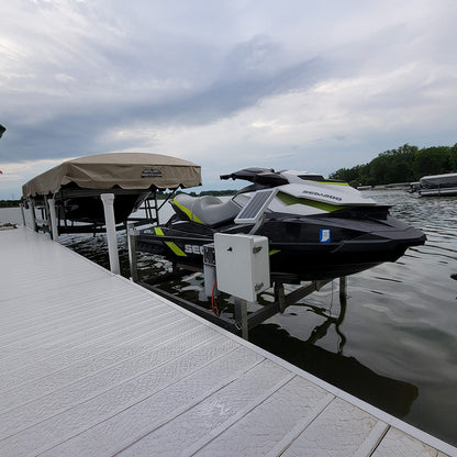 Jet ski on a trailer at a dock with a cloudy sky