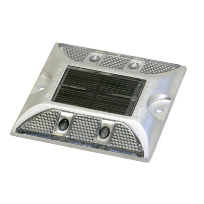 A silver-colored solar deck light with a solar panel on top and LED lights integrated into the design.
