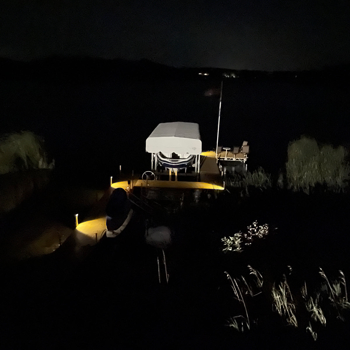 Boat on a dock at night with minimal lighting