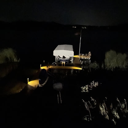 Boat on a dock at night with minimal lighting