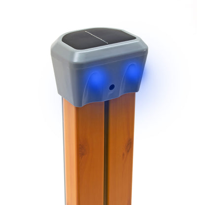 Solar-powered dock light attached to a wooden post with a white background