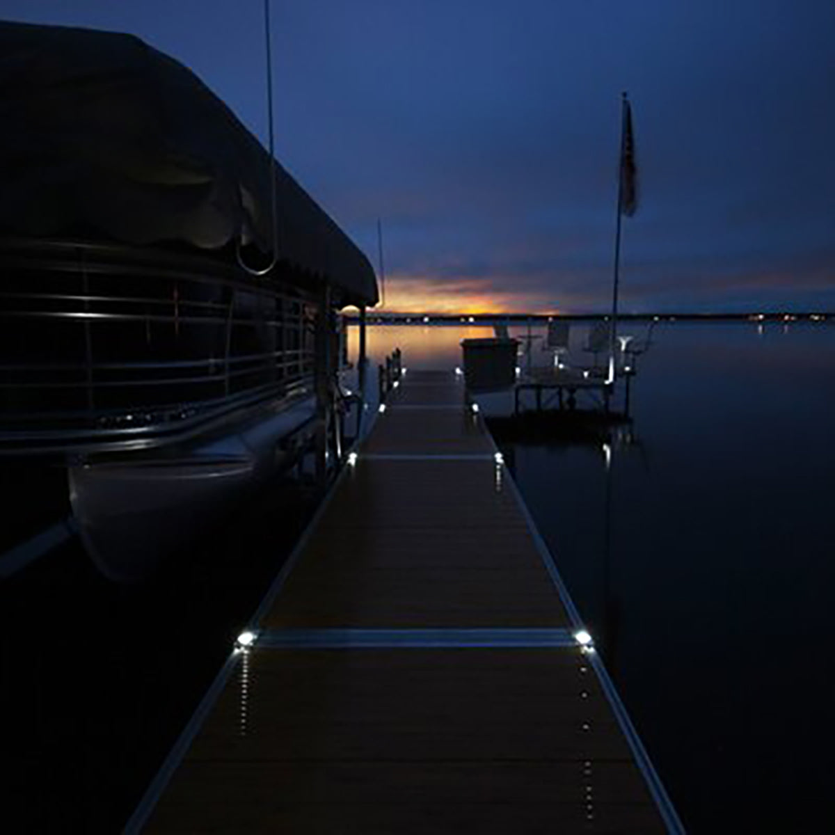 Dock with boat at night on a calm body of water