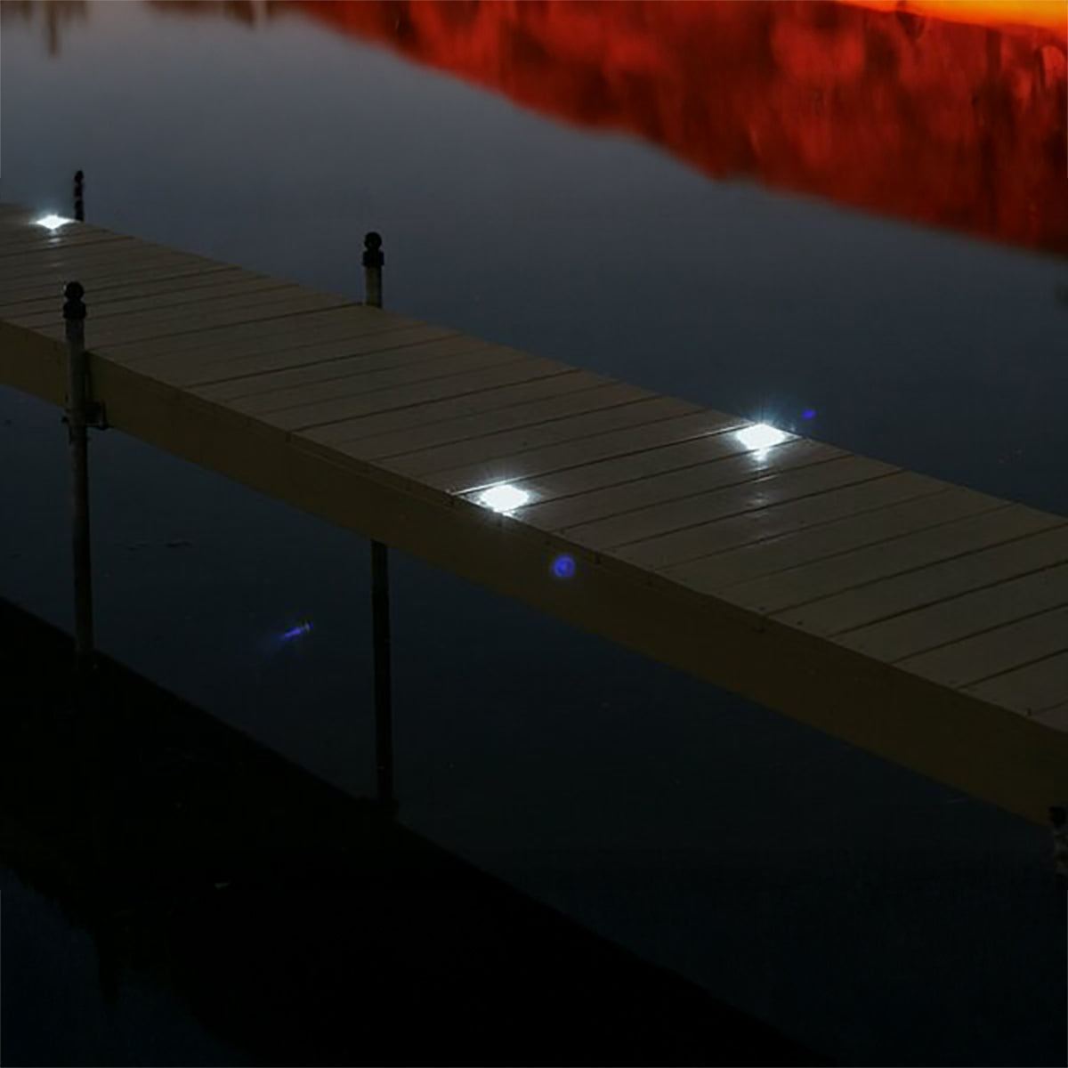 Wooden dock with solar lights on a dark evening