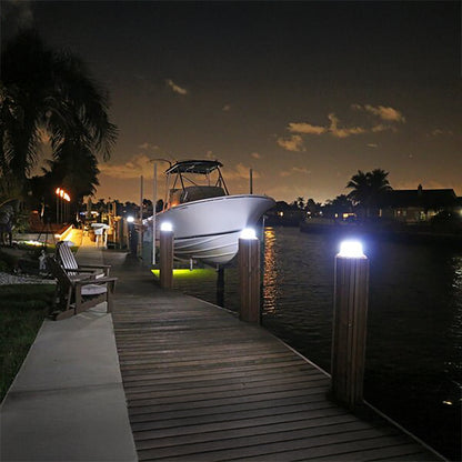 Boat docked at a marina with illuminated posts at night