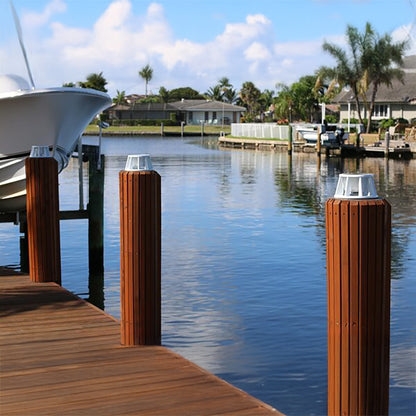 Wooden dock with moored boats and a calm water background