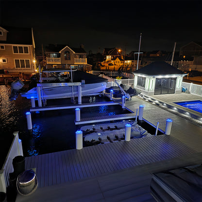 Marina at night with illuminated docks and buildings