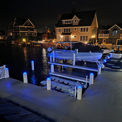 Dock with boats at night in a residential area