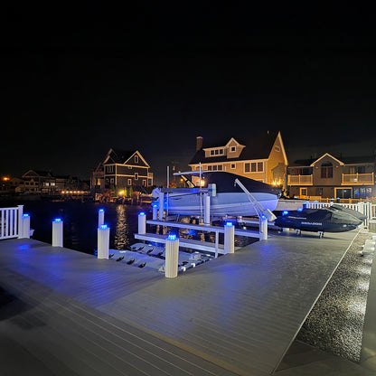 Dock with boats at night in a residential area