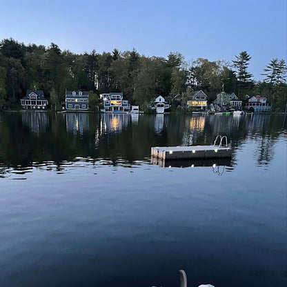 Cottages along a lake with a dock in the foreground