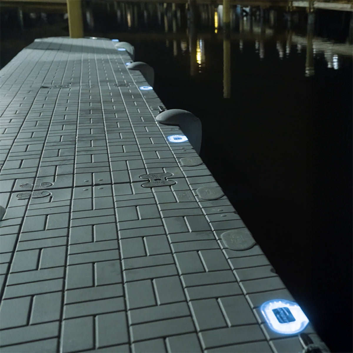 Dark tiled floor with glowing blue lights in a dimly lit room