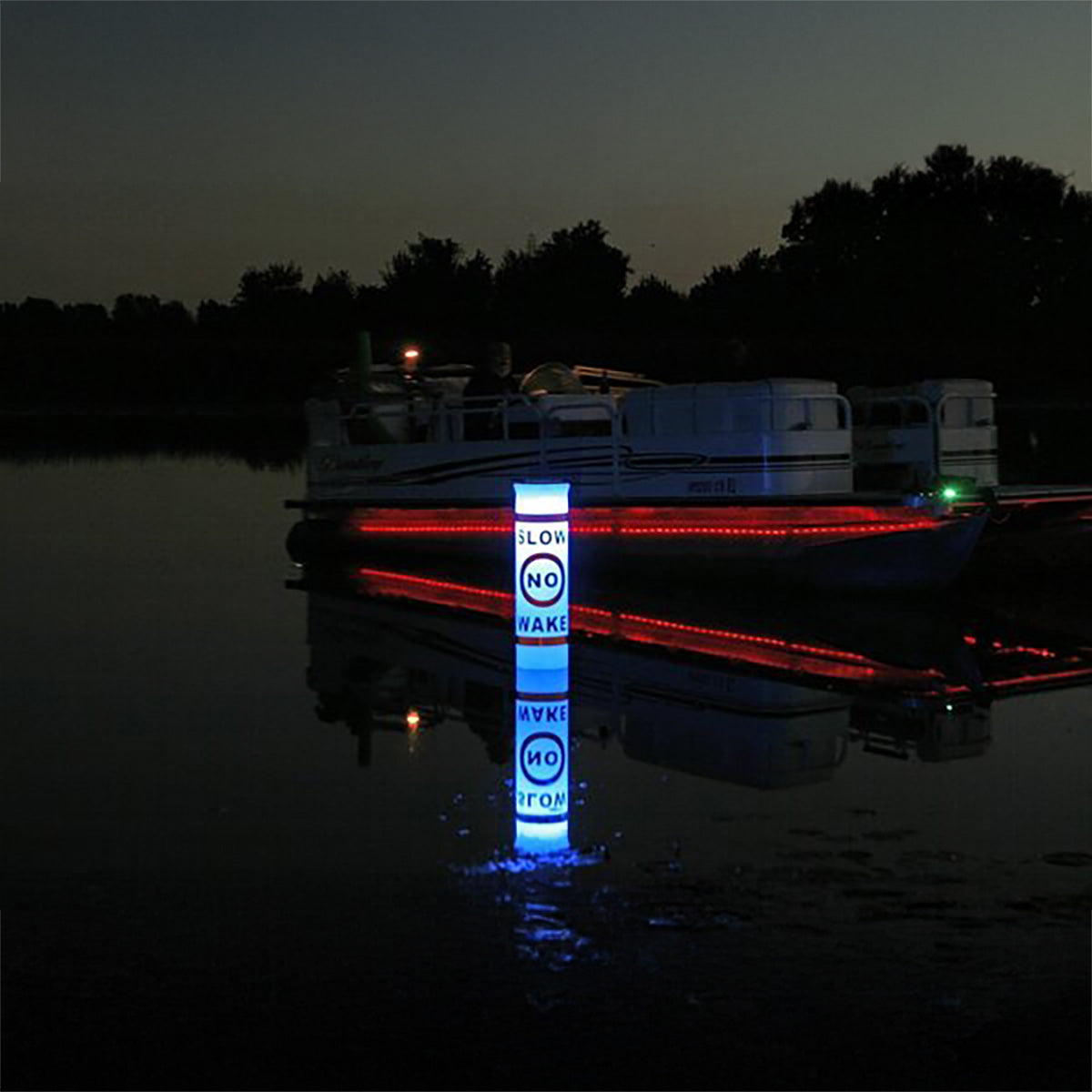 lighted buoy in the water at night