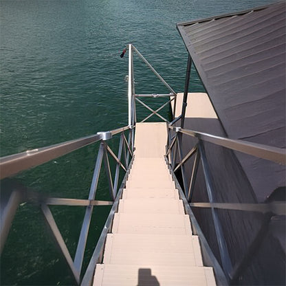 Stairway leading down to a body of water with a metal railing.
