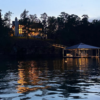 Evening view of a house and dock by a lake