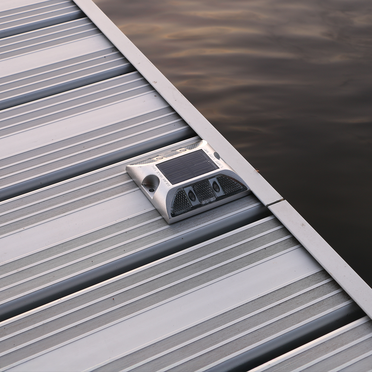 Solar deck light mounted to aluminum dock. 