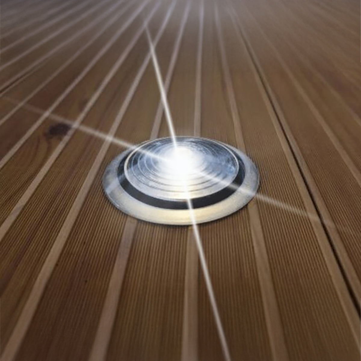 Solar dot light glowing white on a FLOE dock at night